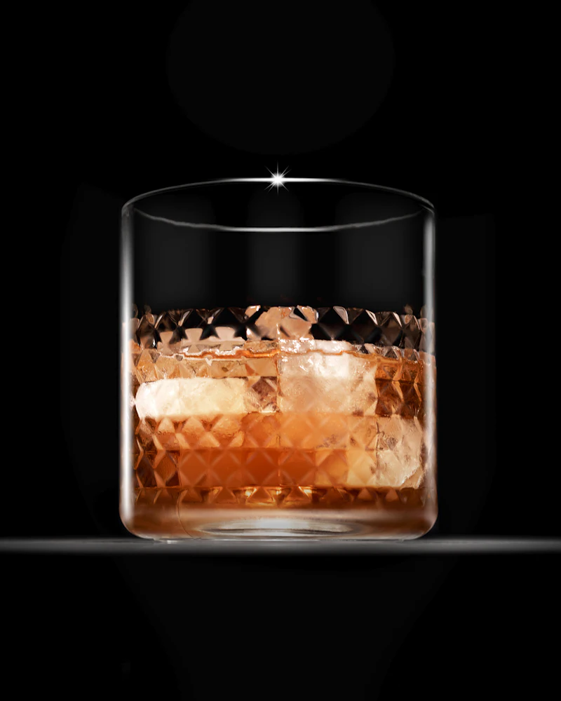 A crystal glass of whisky on a black surface